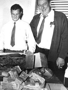 Smiling squad chief Det-Sgt Jack McNeill (right) and Det Ross Bradley proudly display $132,480 in $20 notes recovered from the Qantas haul. Picture: The Herald Source: HWT Image Library 